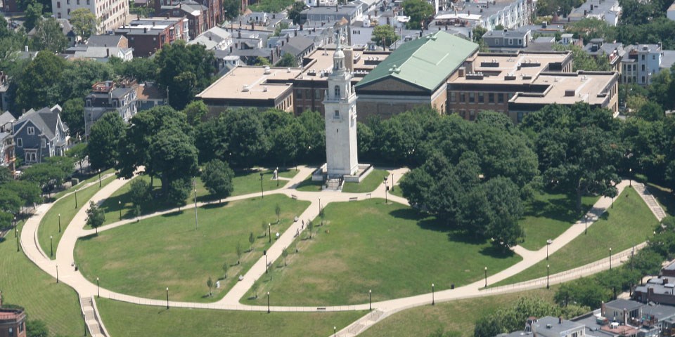 Aerial photograph showing white marble monument in an elliptical park. Sidewalks wind around the ellipse and up the center toward the monument.