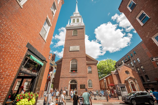 a brick church with a white steeple