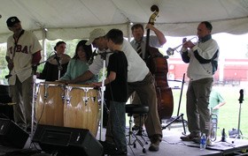 Musicians play drums, bass and trumpet with students at the Latin jazz Workshop.