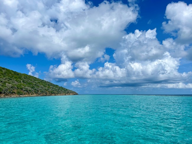 View of the lagoon at Buck Island with the sea, clouds and Buck Island