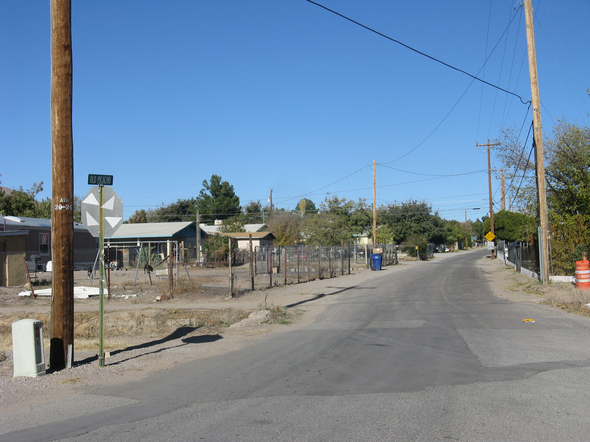 An empty side street next to a building.