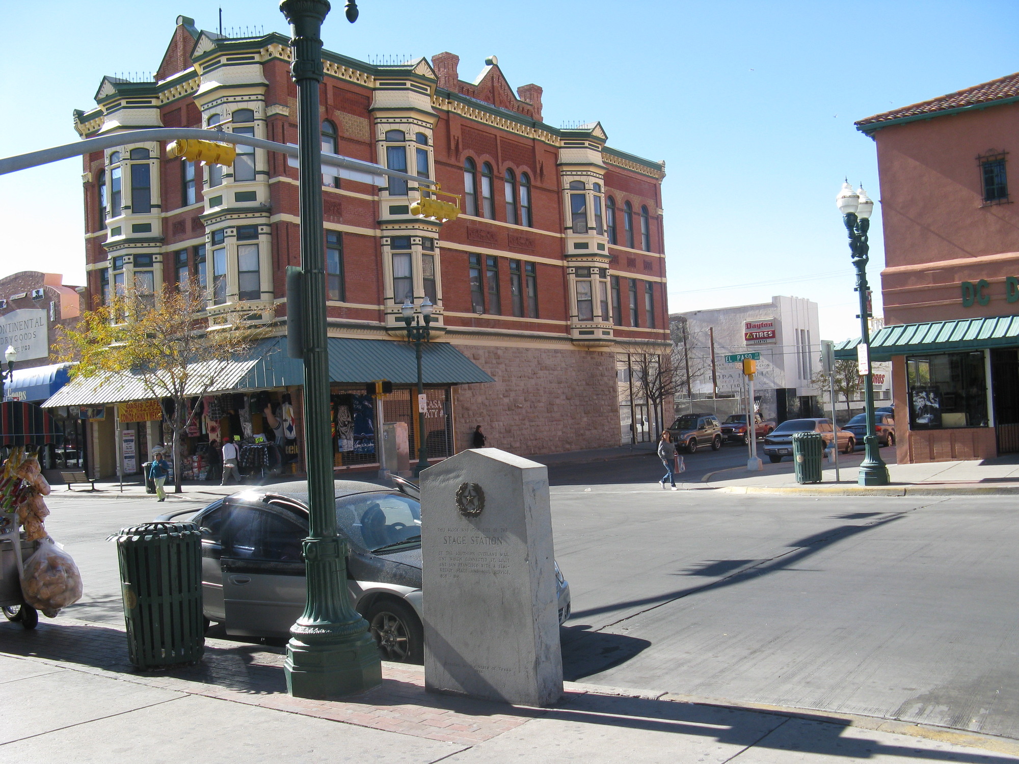 A monument stands next to an empty street in a city.