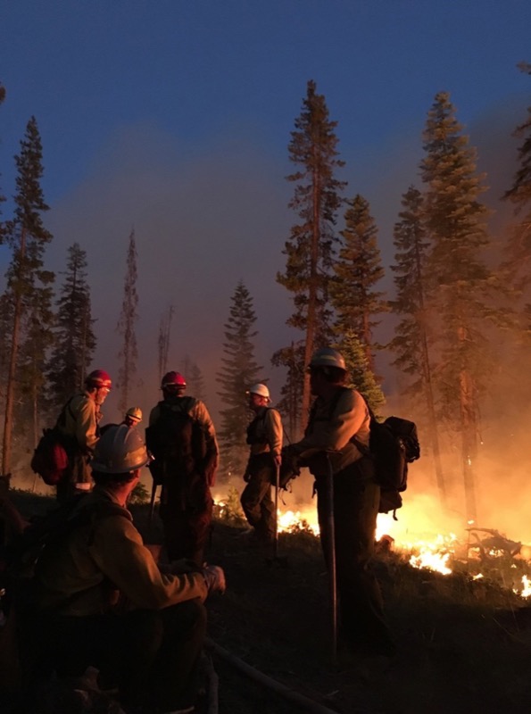 A group of firefighters have a safety meeting