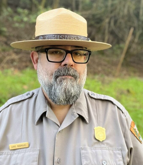 Man with a beard is in a ranger hat and uniform.