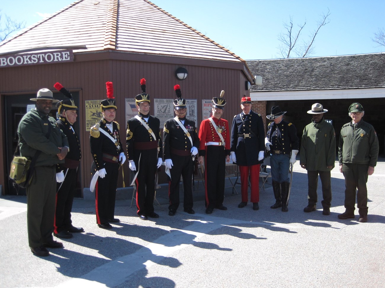 Park Rangers and Soldiers pose for a photo inside a fort