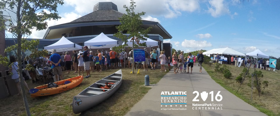 Visitors crowd Science Street Fair exhibits at the Atlantic Research and Learning Center at Cape Cod National Seashore's Centennial event.