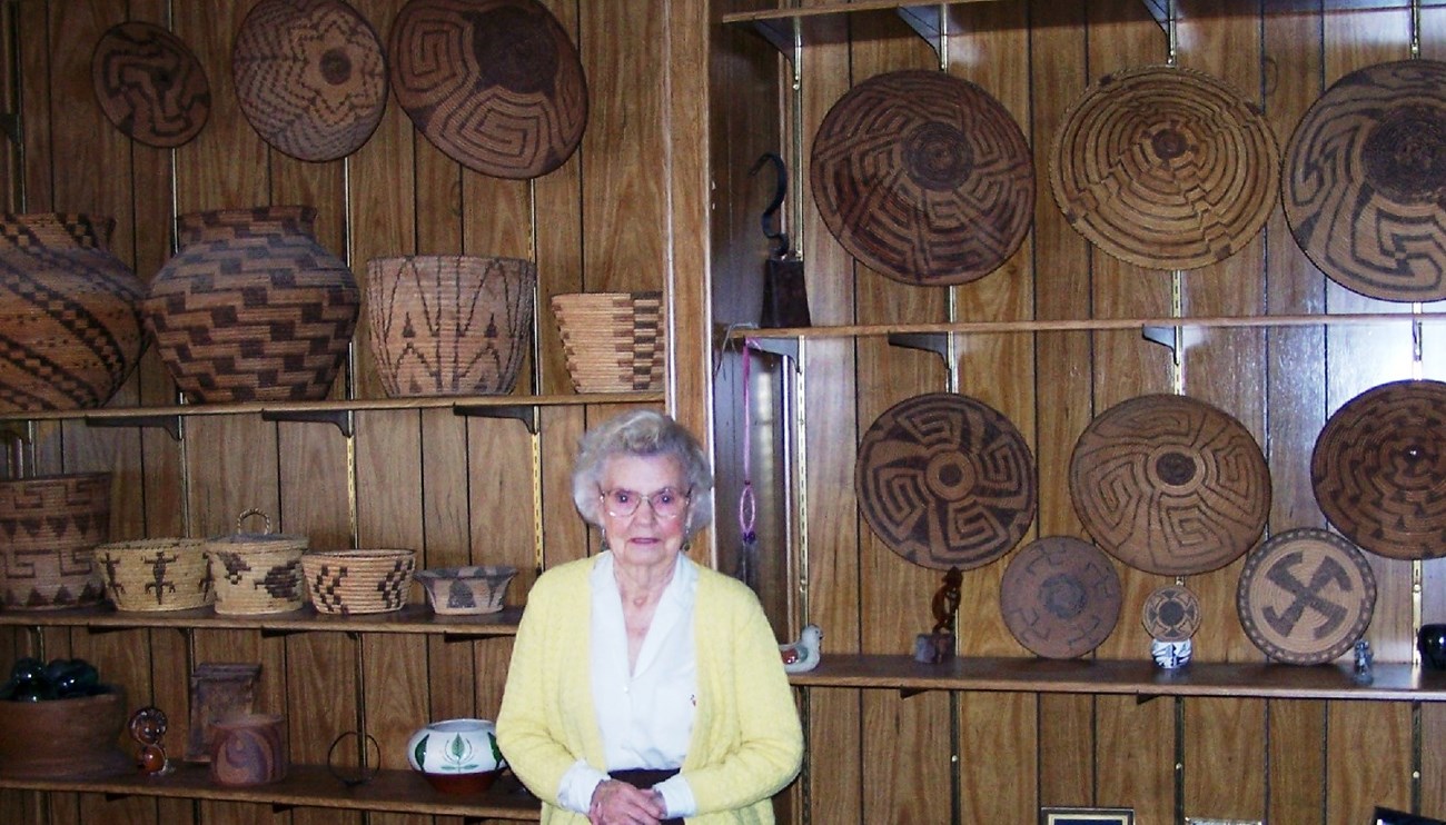 Dorothy Fadick with Basket Collection in her home.