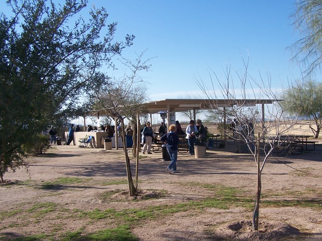 View of the covered picnic area with the ramps to the ancient ballcourt overlook in the background.