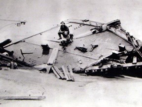 Rasmus Midgett sitting on the wreck of the Priscilla