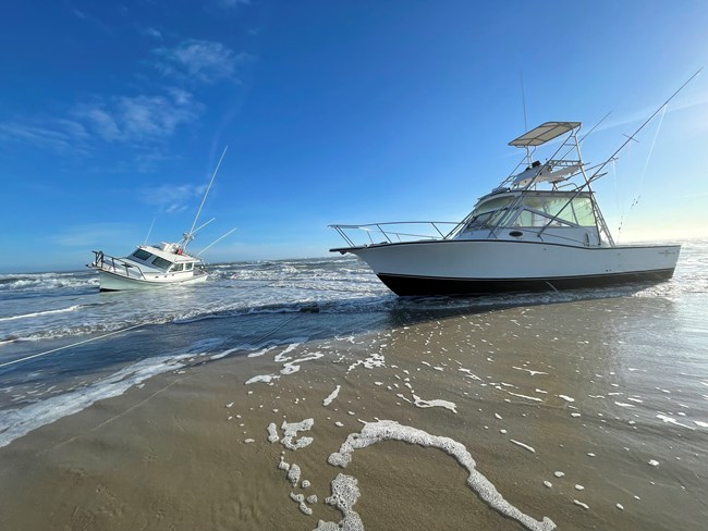 Two vessels grounded on the beach.