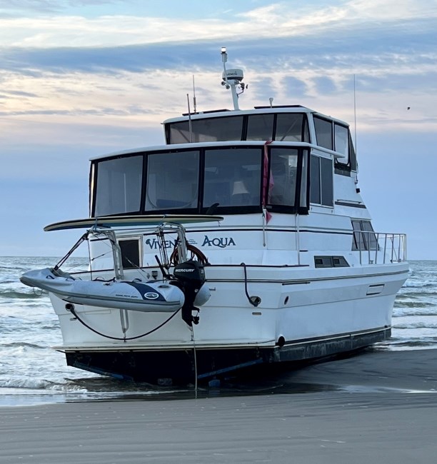 A vessel firmly resting on the beach, waiting to be removed.