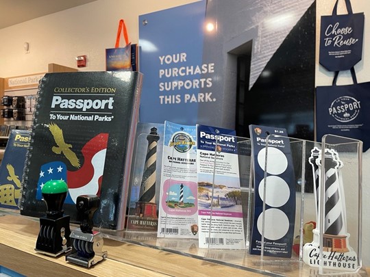 View of store shelf with NPS Passport Book, bookmarks, and stamps.