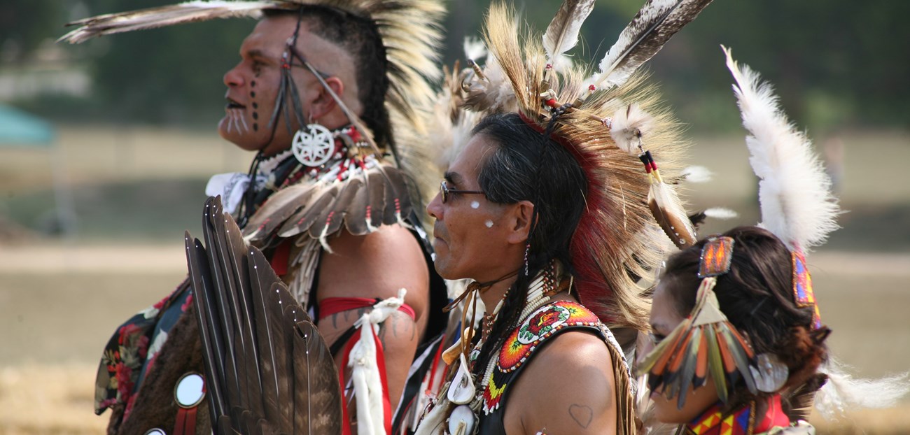 Dancers at a powwow wearing regalia.