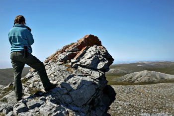 woman standing on a rock perch