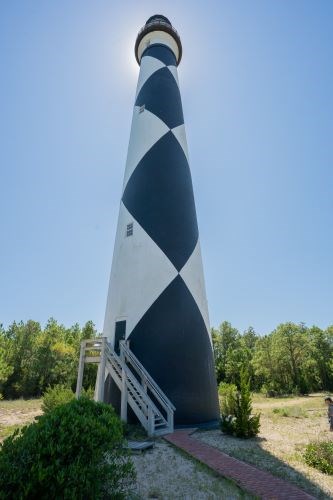 Cape Lookout Lighthouse with a blue, cloudless sky behind it.