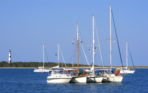 A variety of boats anchor off shore at Cape Lookout National Seashore.
