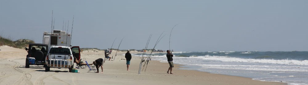 Surf fishermen with their vehicles.