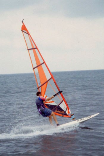 A windsurfer sails across the waters of the sound.
