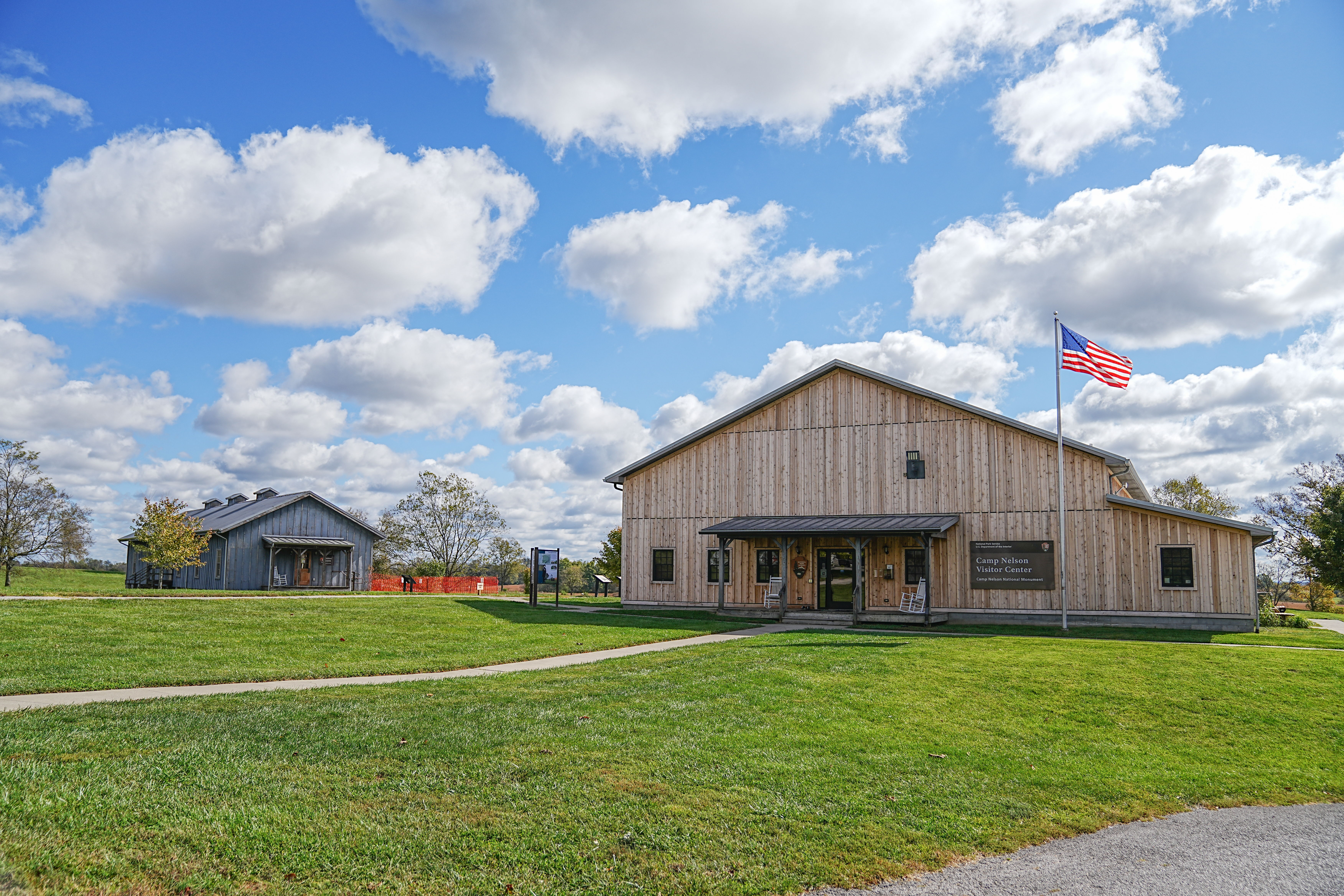The Camp Nelson National Monument Visitor Center and Barracks Building side by side on a sunny day.