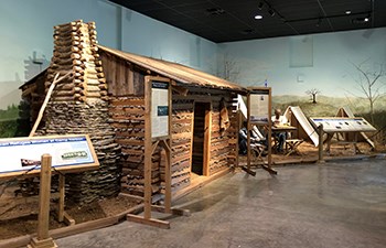 Life size cabin display as part of museum exhibit.