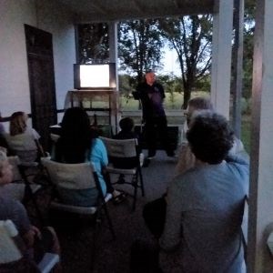 Professor stands before crowd, teaching about night sky