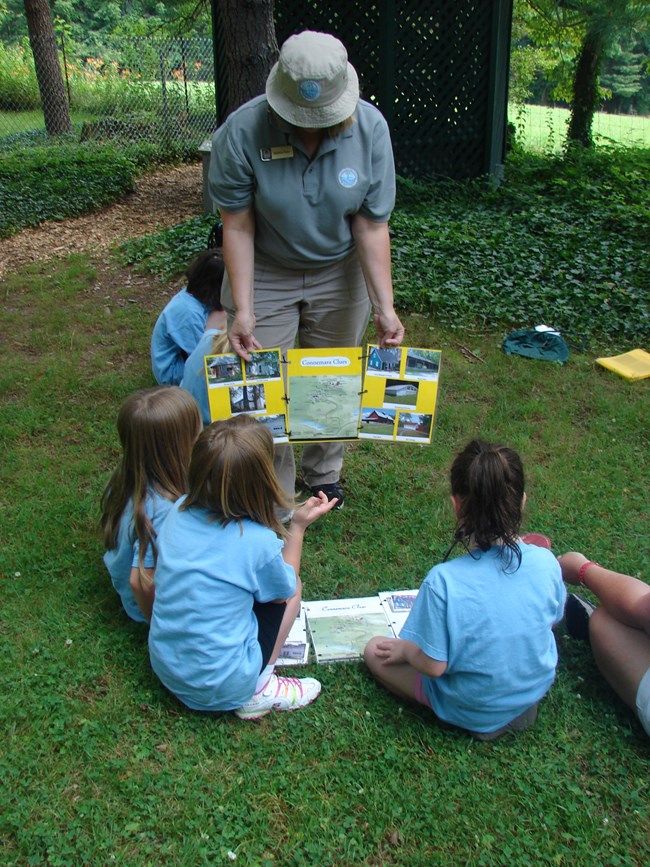 Teacher and students enjoy a lesson outside