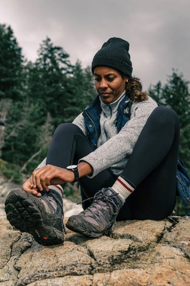 woman tying laces on hiking boots