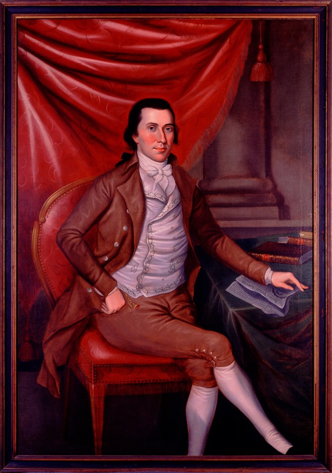 A portrait painting shows a young man in fancy 1700s clothes.