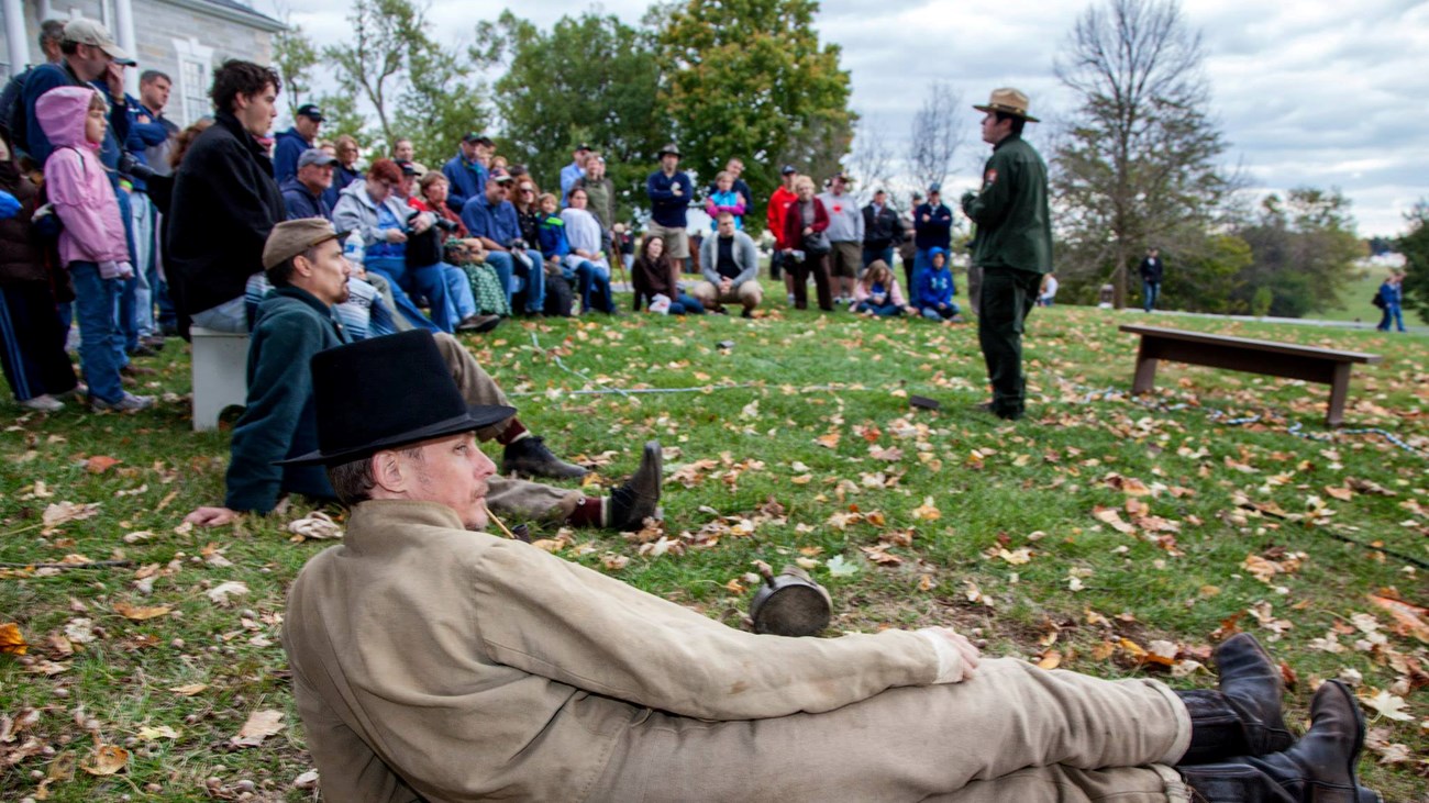 A National Park Service ranger talks to a group of visitors in front of Belle Grove Plantation.