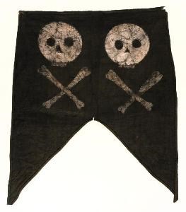 Black fabric with straight top edge descending into two points on bottom edge. Two skull-and-crossbone symbols painted in white.