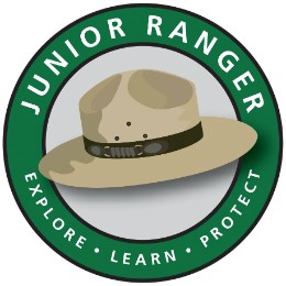 Junior ranger logo - the words "Junior Ranger: explore, learn, protect" in a circle around a ranger hat