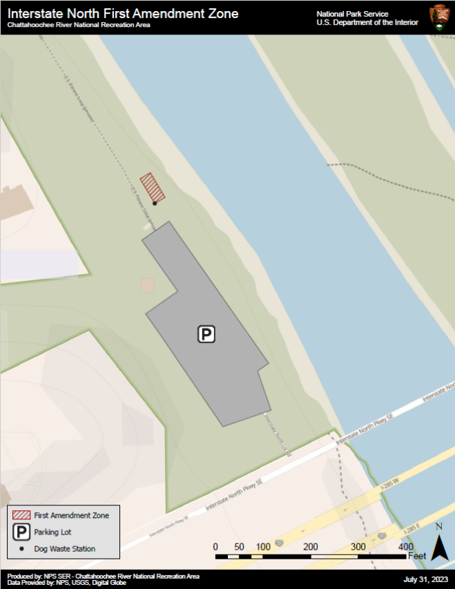 First Amendment Area is between the gravel fitness trail and the river as you enter the trail from the parking lot.