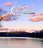 AirNow Logo superimposed over a photograph of scattered pinkish clouds drifting over the river in the evening.