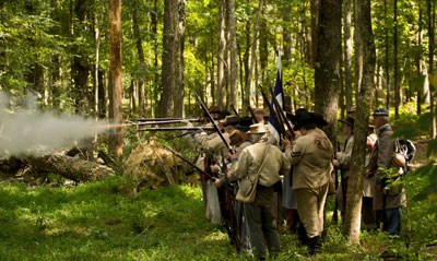 Confederate living historians fire in the woods of Chickamauga Battlefield