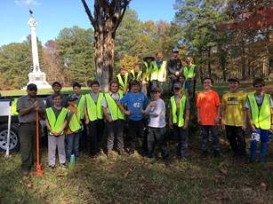 young people and a park ranger posing after a trail cleanup