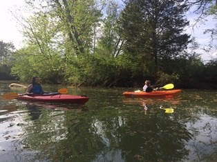 Two kayakers paddle West Chickamauga Creek near the park boundaries.
