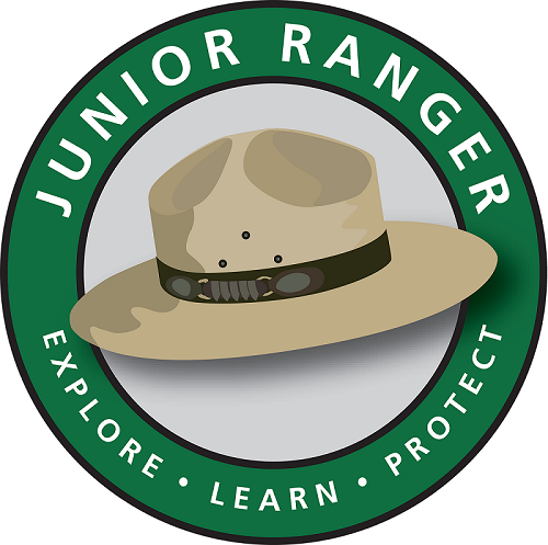 A green circle that says Junior Ranger - Explore, Learn, Protect and a flathat displayed in the middle.