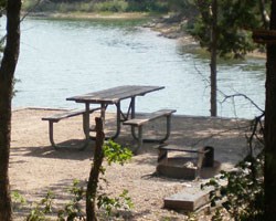 Empty campsite with picnic table and fire ring
