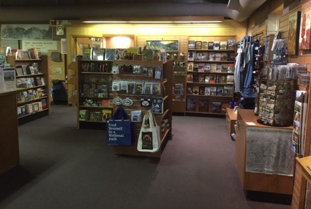 Bookstore with books, tote bags, and other souvenirs on shelves.