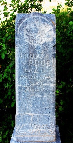 Tall, narrow, stone grave marker.