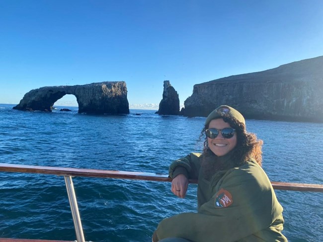 woman on boat with arch in background