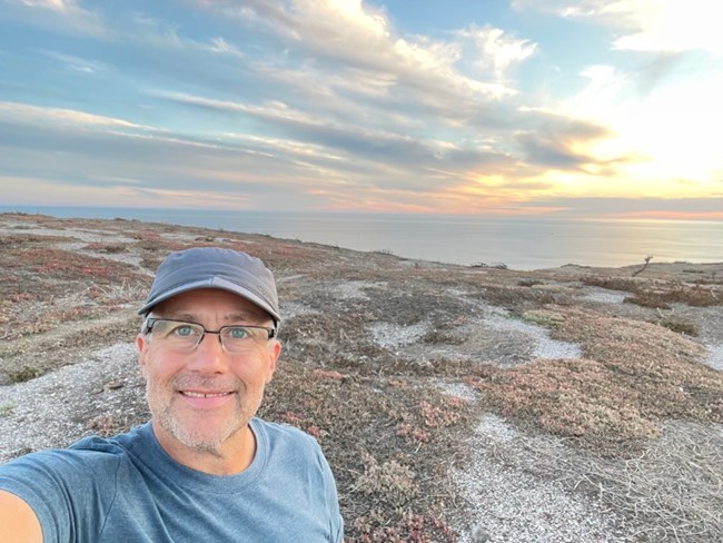 man taking picture of himself overlooking ocean