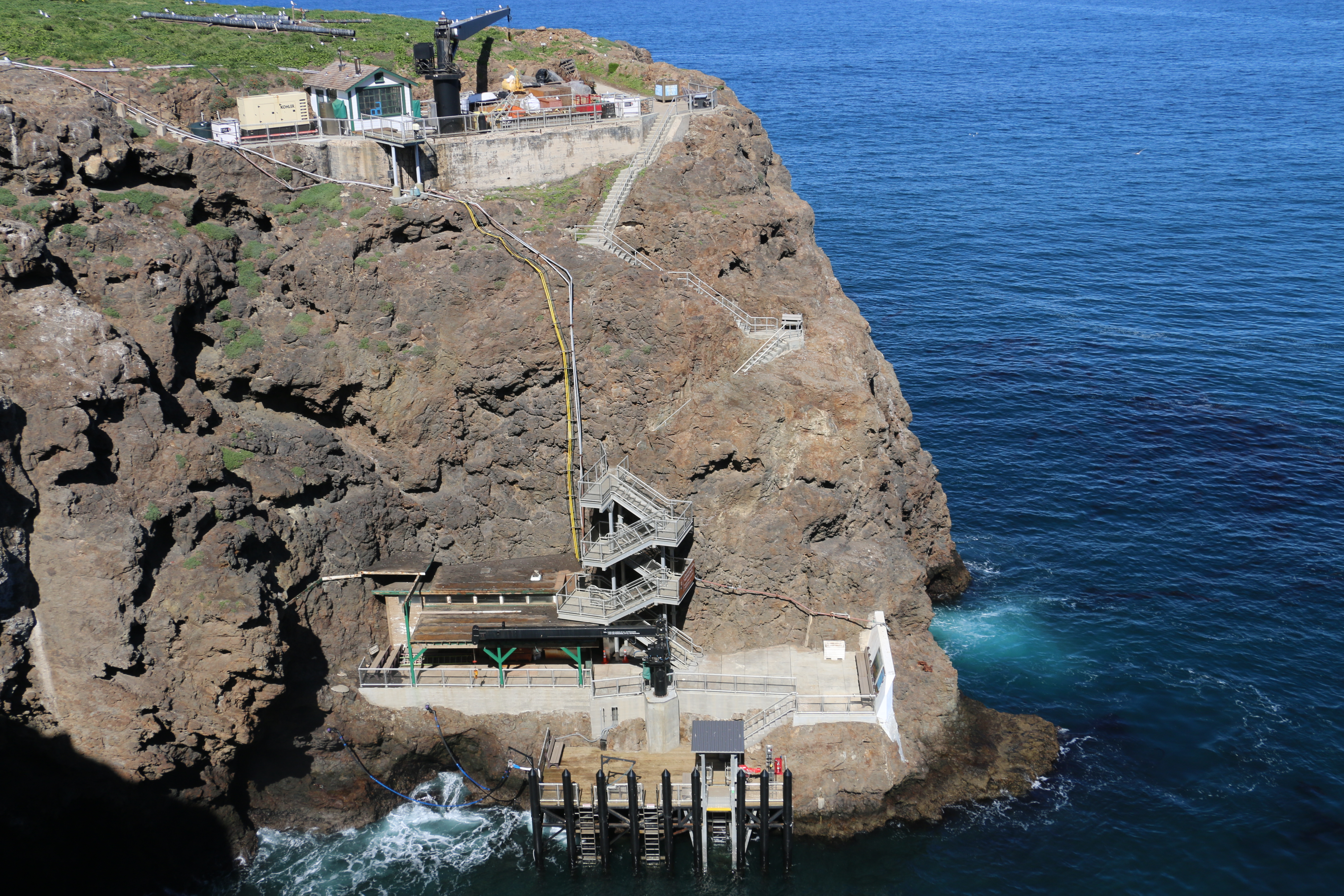 steep coastal bluff with dock and crane