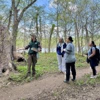 Park guide and visitors on River Trail