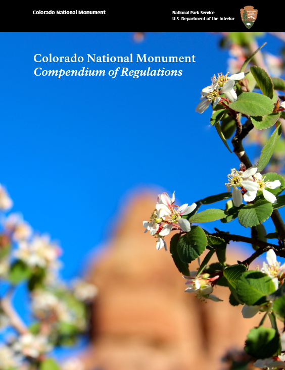 The cover of the Compendium of Regulations with cliffrose in the foreground and an orange sandstone formation in the background contrasted with a bright blue sky.