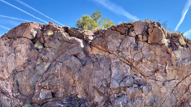 Rough, grayish/purplish rocks in canyon bottoms