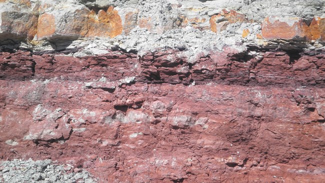 Brick red, crumbly rock layers