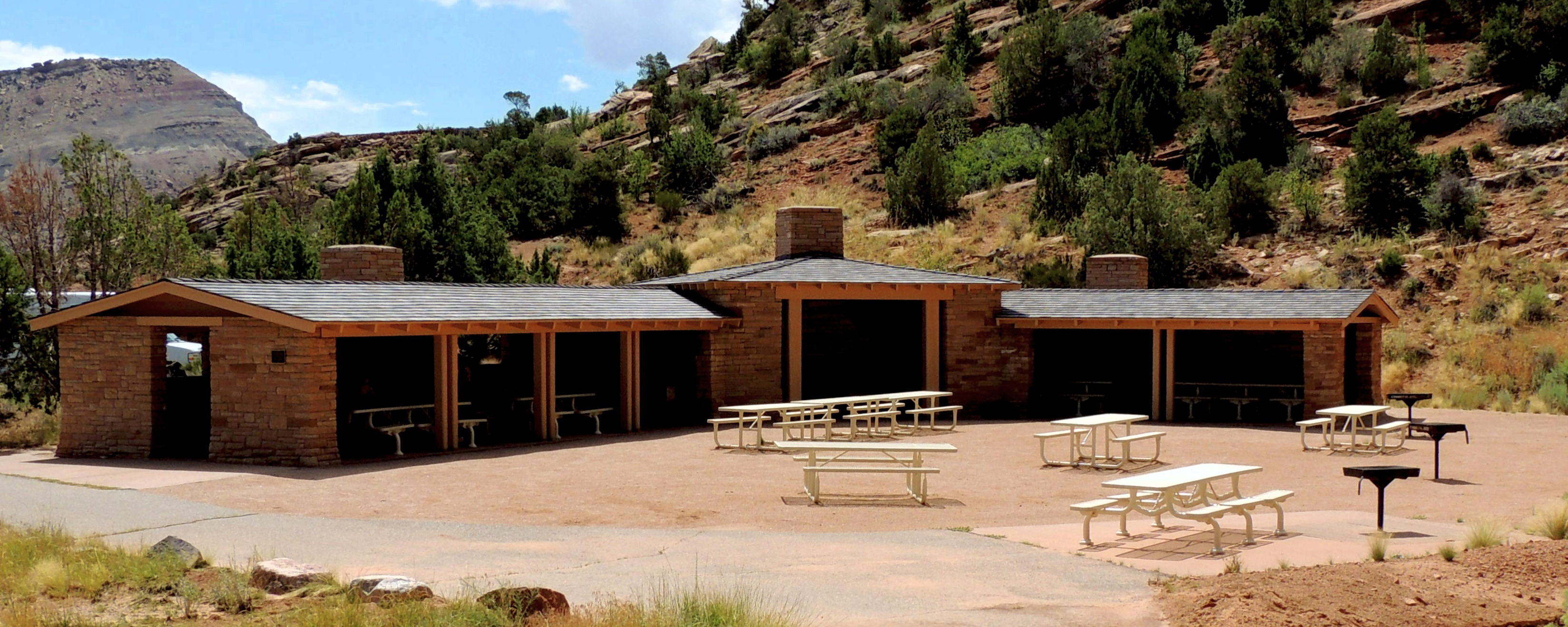 stone shelter with open entryways and picnic tables