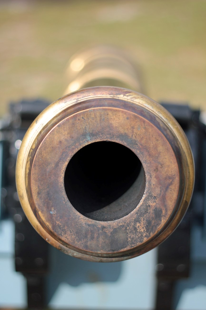 The picture looks down the barrel of a cannon