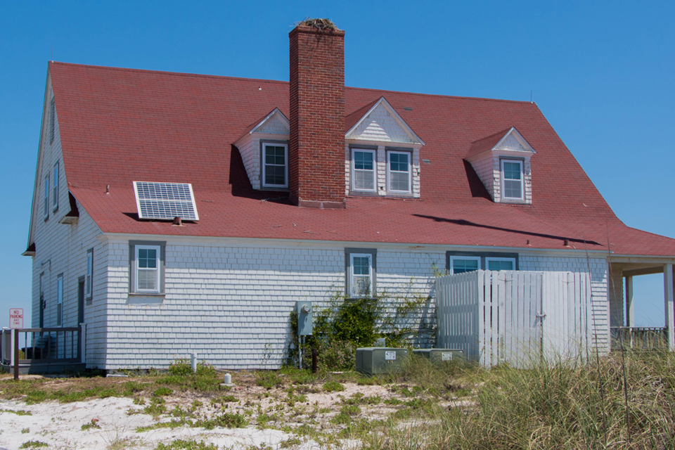 Black and white photo of a two story wooden building.
